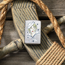 Lifestyle image of Sailor Girl Tattoo Design Street Chrome?äó Windproof Lighter laying on a ships helm with rope around it.