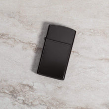 Lifestyle image of Slim?« Brown Windproof Lighter laying on a marble surface