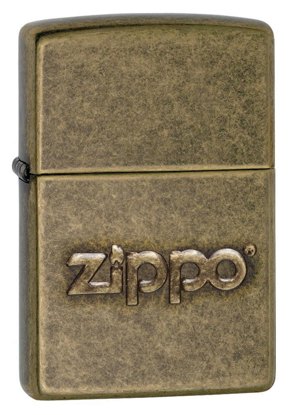 Front shot of Zippo Stamp Antique Brass Lighter standing at a 3/4 angle