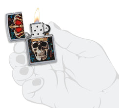 Skull King Design Street Chrome™ Windproof Lighter lit in hand.