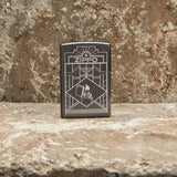 Lifestyle image of Zippo Art Deco Design Black Ice® Windproof Lighter standing on a counter top.