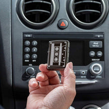 Lifestyle shot of Cassette Tape Black Ice?« Windproof Lighter in a car in hand