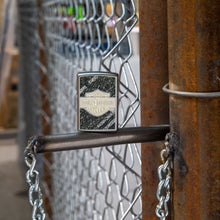 Lifestyle image of Harley-Davidson® Bar & Shield Asphalt Street Chrome™ Windproof Lighter standing in a garage scene.