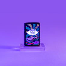 Lifestyle image of Black Light Eye Design Black Matte Windproof Lighter glowing under a black light..