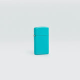 Lifestyle image of Slim® Flat Turquoise Windproof Lighter standing in a grey scene.