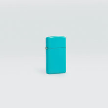 Lifestyle image of Slim?« Flat Turquoise Windproof Lighter standing in a grey scene.