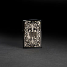 Lifestyle image of Zippo Logo Filigree Design High Polish Black Windproof Lighter standing in a black background.